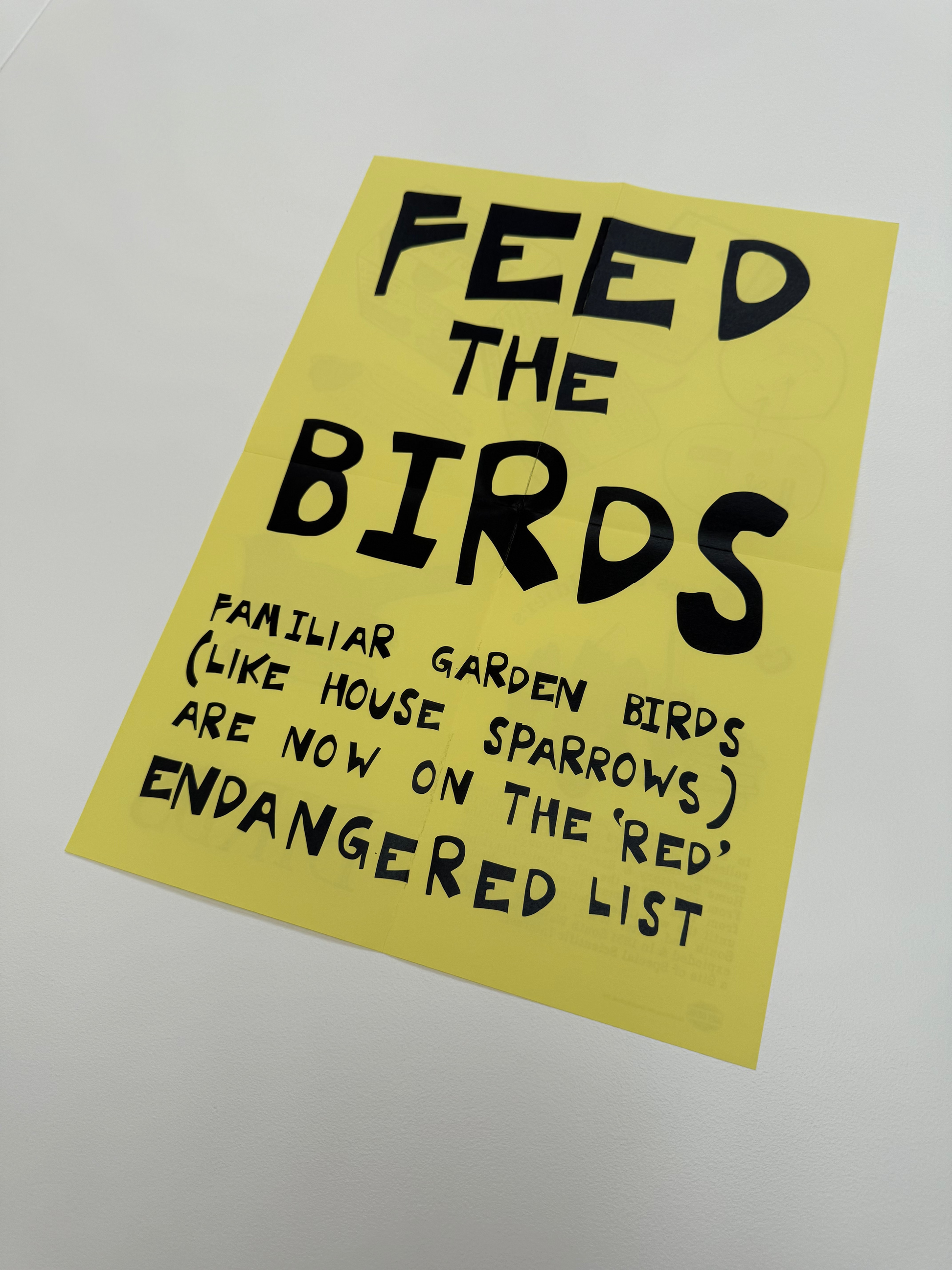 Yellow paper artwork with black text on a white background